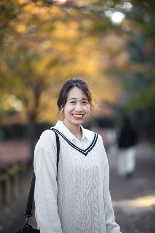 A Woman in White Knitted Sweater Smiling