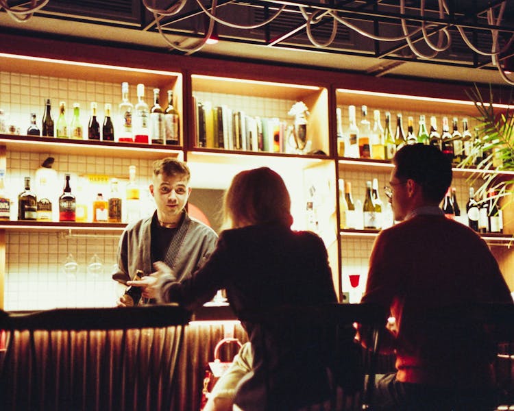 Couple Sitting At Bar Counter