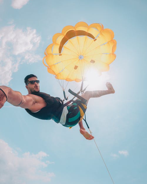 Fit Young Man Parasailing and Making Selfie