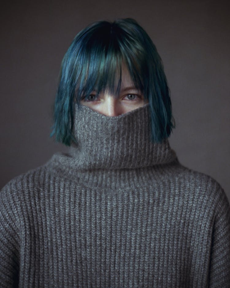 Photo Of A Woman With Blue Hair Wearing A Gray Sweater