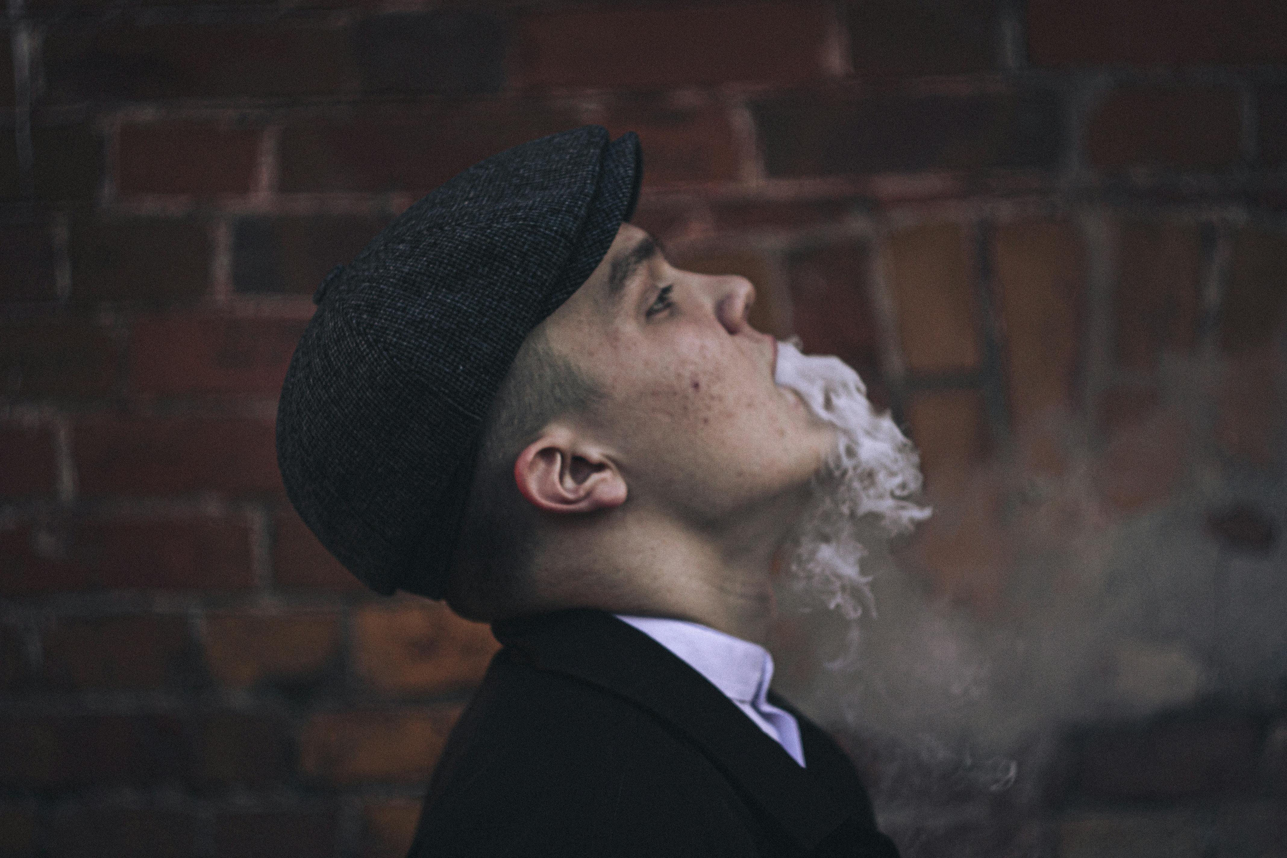 a side view of a man smoking