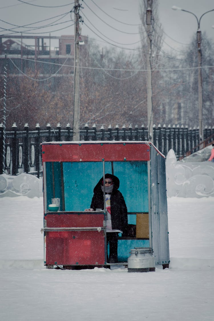 Woman In Warm Clothing In Free Standing Shop 