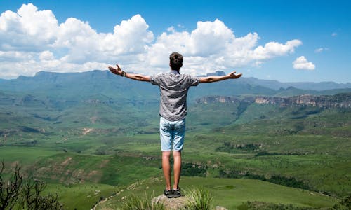 Free Man Wearing Grey Shirt Standing on Elevated Surface Stock Photo