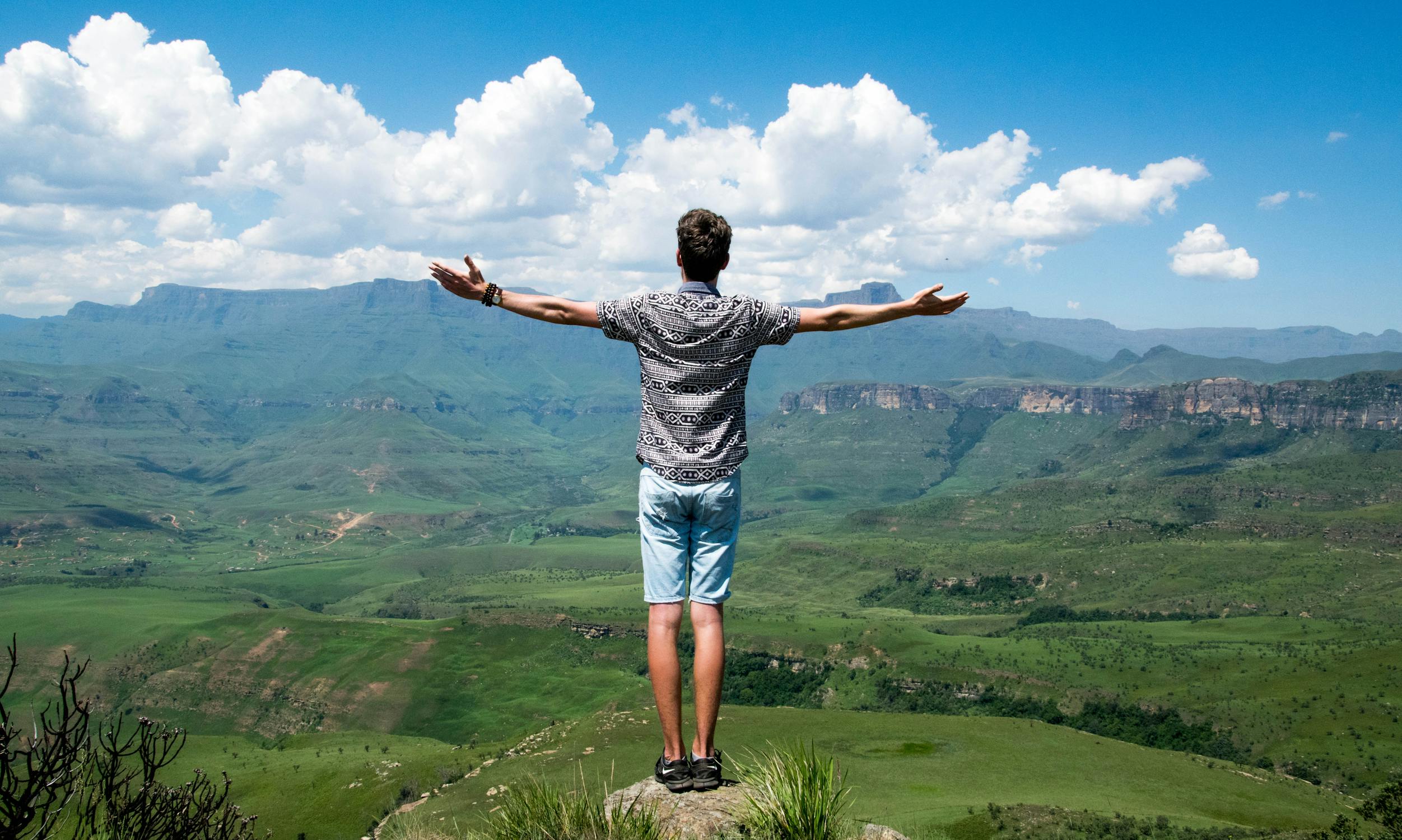 Man Standing on Rock Photo by Julian Jagtenberg from Pexels