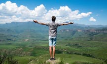 Man Wearing Grey Shirt Standing on Elevated Surface