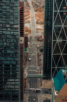 Aerial view of a busy road amidst high-rise buildings in downtown Calgary.