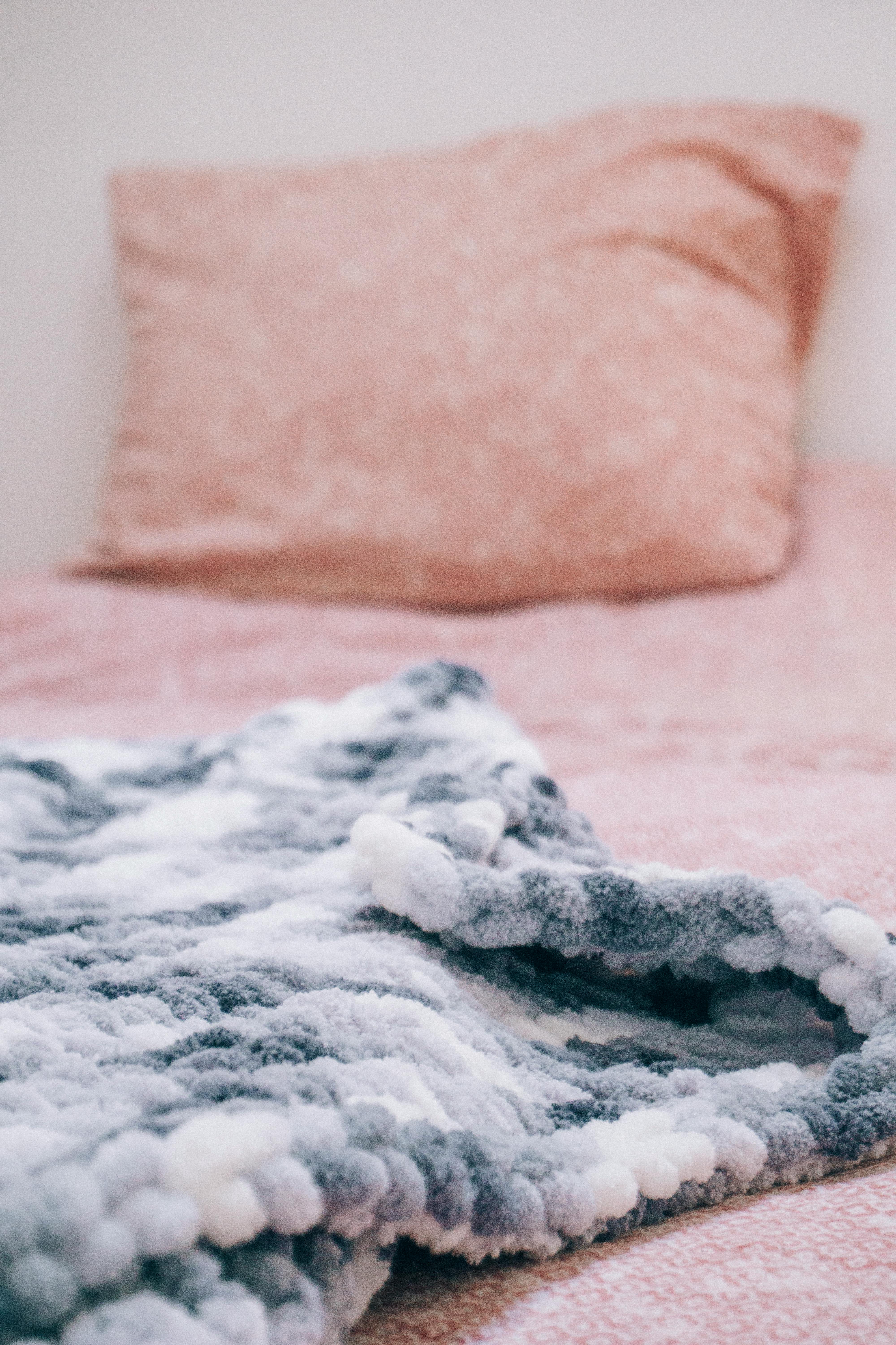 Woman With Curly Hair Lying Down on Bed With White Blanket · Free Stock  Photo