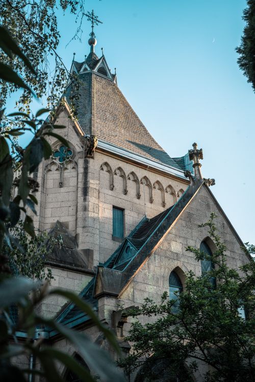 Free Intricate gothic church architecture with pointed arches and steep gabled roof, set against a clear sky. Stock Photo