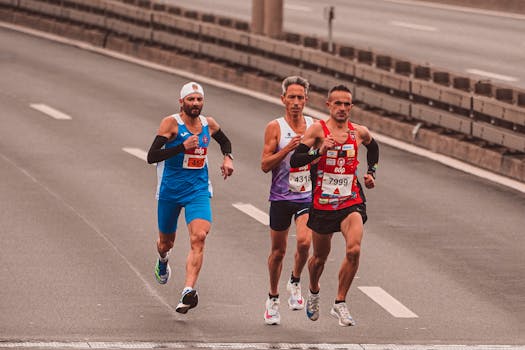 Three male marathon runners on a city street showcasing endurance and competition.