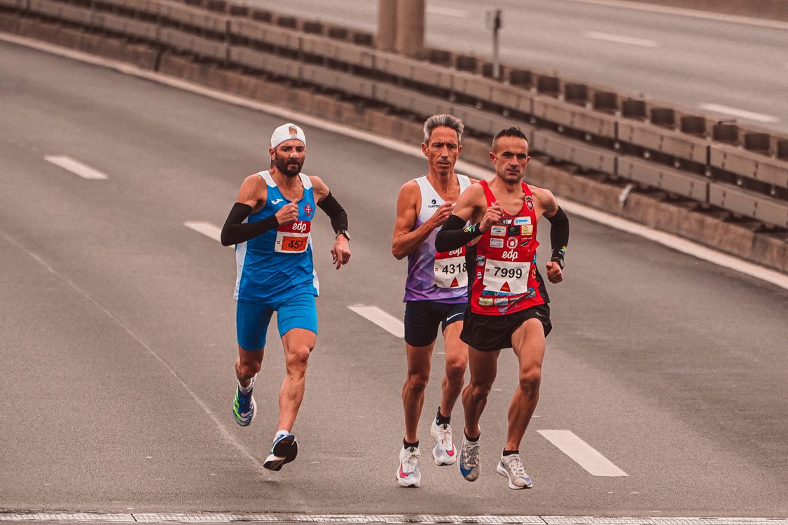Photograph of Men Running on a Road · Free Stock Photo