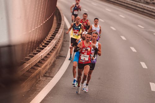 Men Running on the Side of the Road