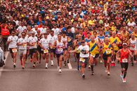People in White and Red Shirts Running on Road