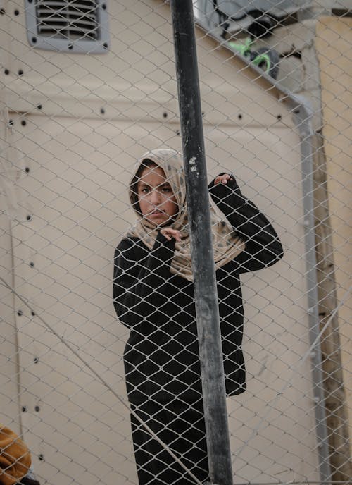 Woman Standing behind the Fence 