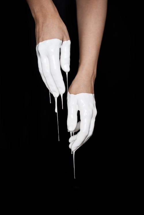 Free Hands Covered in White Paint on Black Background Stock Photo