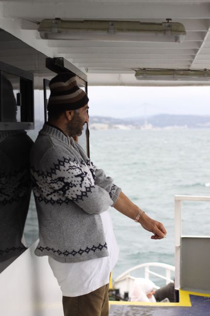 Senior adult man with beanie enjoys a peaceful boat ride across the ocean.