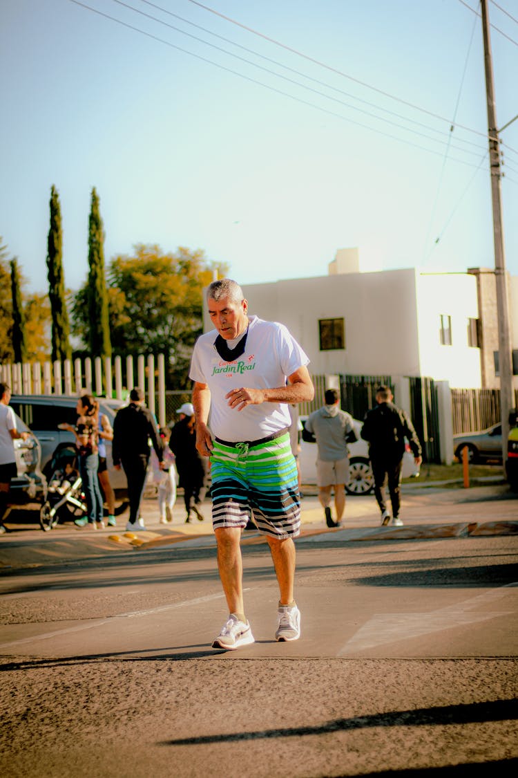 An Elderly Man Jogging On The Street