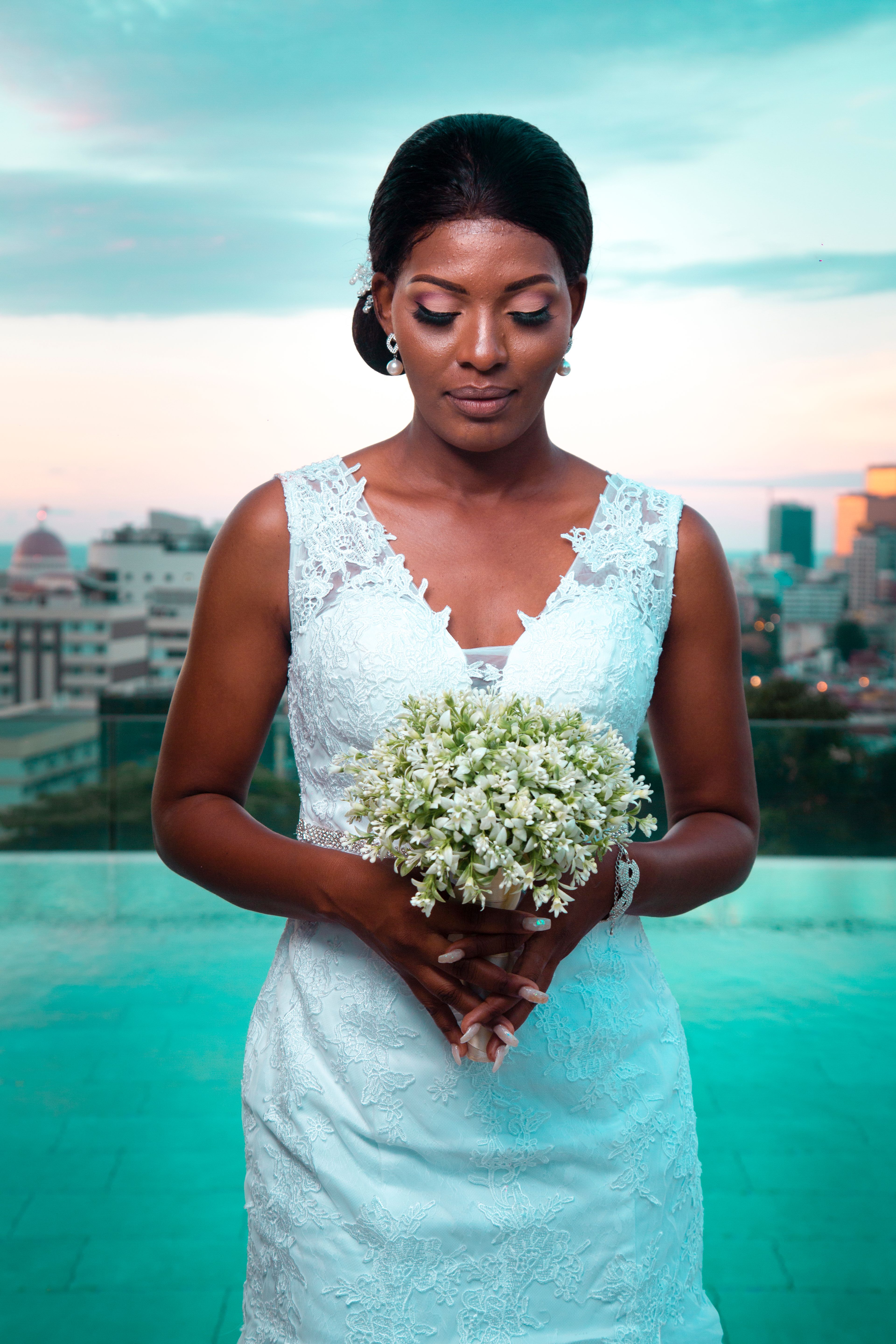 Woman in Bridal Gown Holding Bouquet of White Flowers · Free Stock Photo