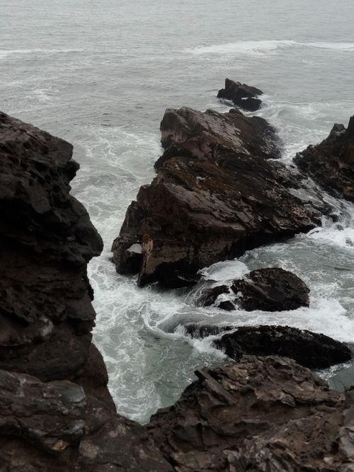 Free A captivating view of ocean waves crashing on a rugged rocky coastline. Stock Photo