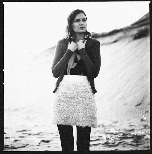 Monochrome Photograph of a Woman Wearing a Skirt