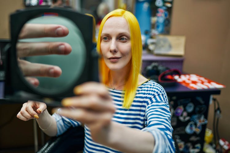 Nail Technician Using Magnifying Glass