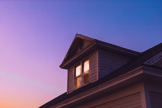 A serene twilight view of a wooden house rooftop with a vibrant sky background.