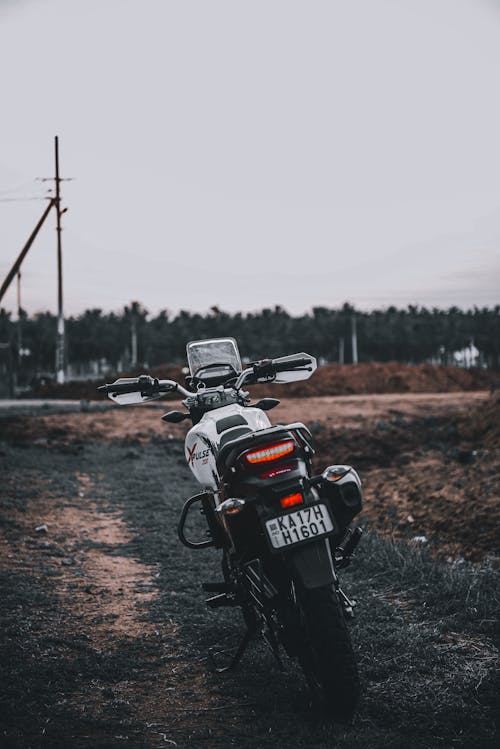 Motorcycle Parked on Dirt Road
