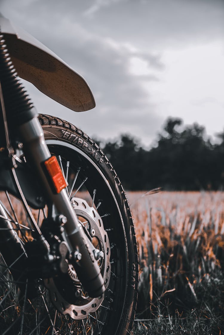 Front Wheel Of Motorbike Standing In Fields