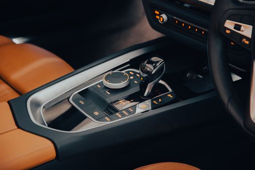 Close-up view of a premium car interior featuring leather seats and a modern control panel.
