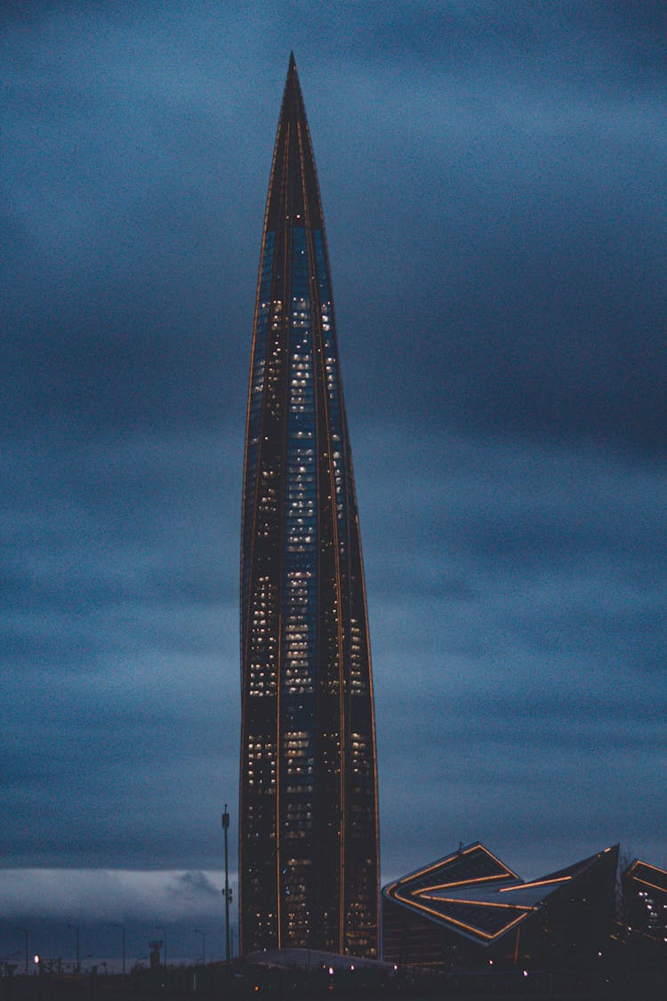 Modern Skyscraper On Sky Background At Night