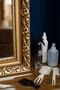 Golden ornate mirror and hair styling tools creating a chic salon atmosphere.