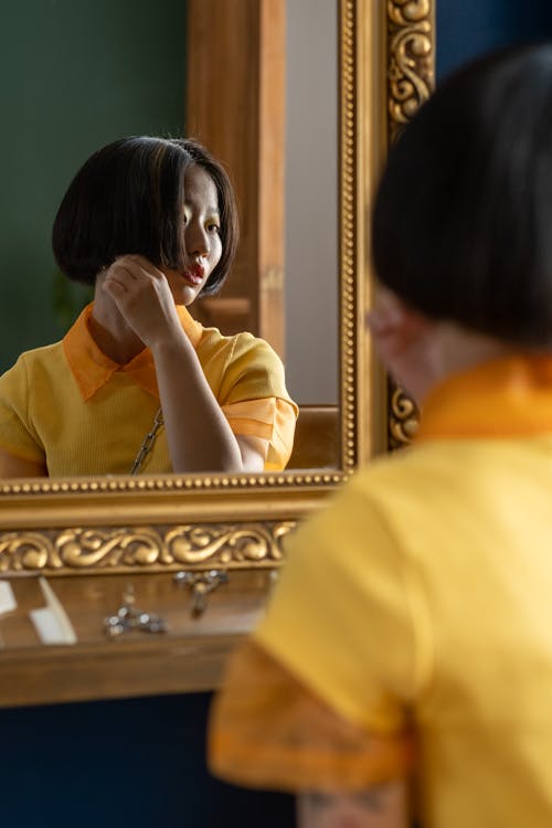 Free Woman Looking in Mirror  Stock Photo