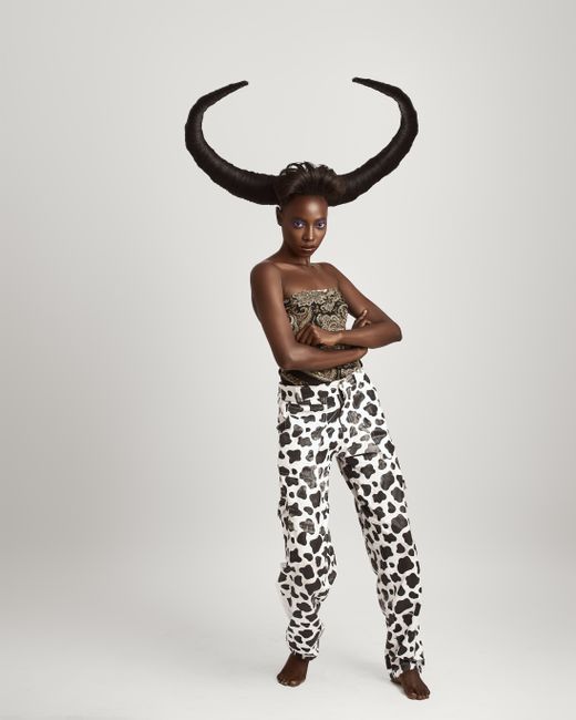 Striking portrait of a model with horned hairstyle in artistic fashion.
