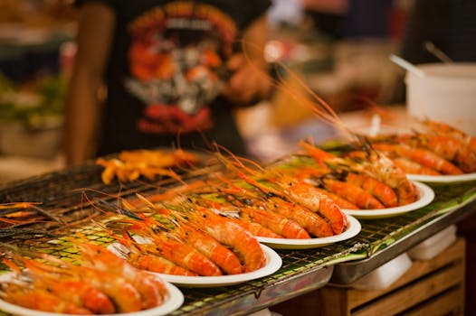 Deliciously grilled shrimps on plates ready to serve at a vibrant Bangkok street food market.