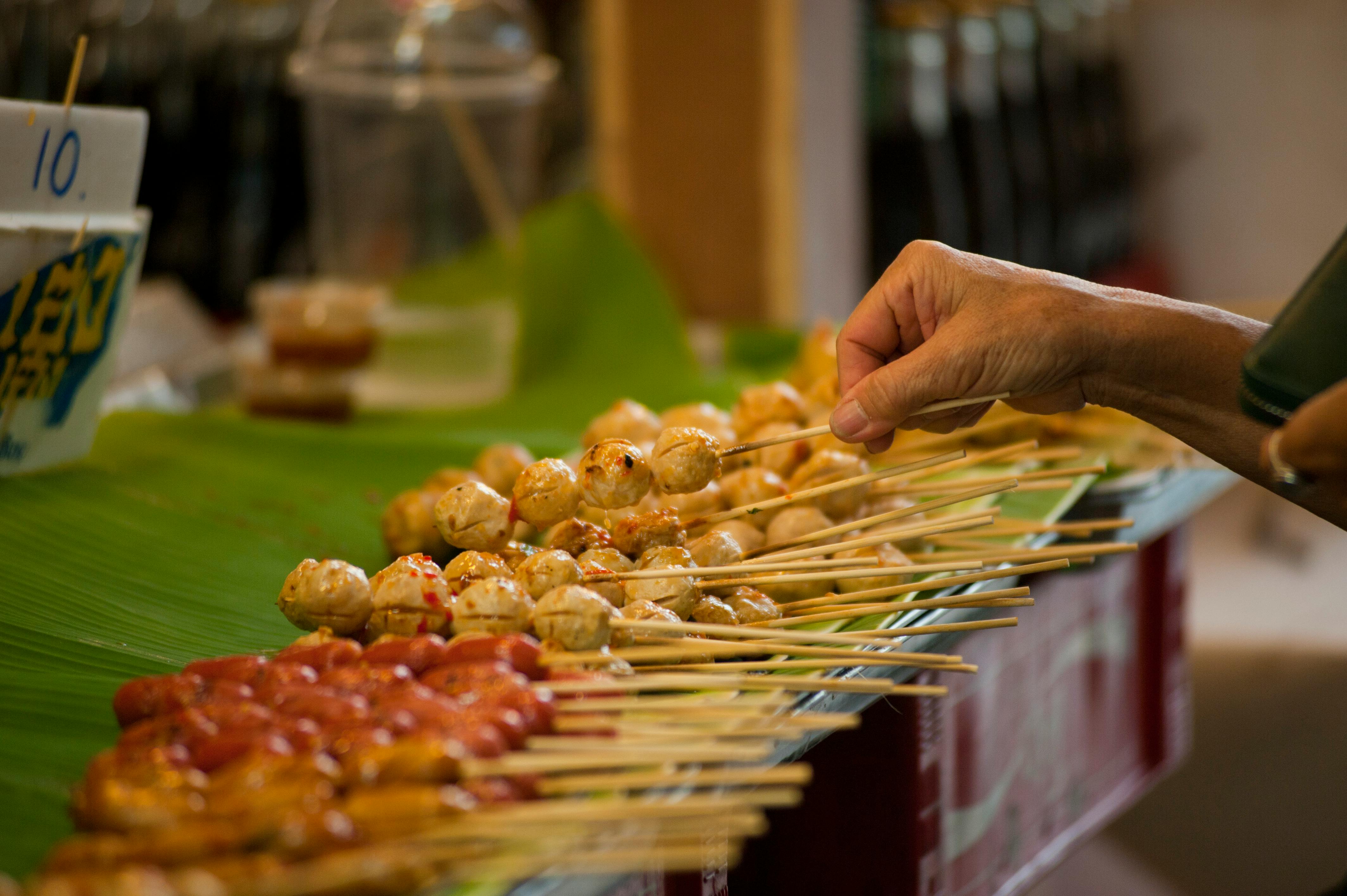 tilt shift photography of street foods in stick