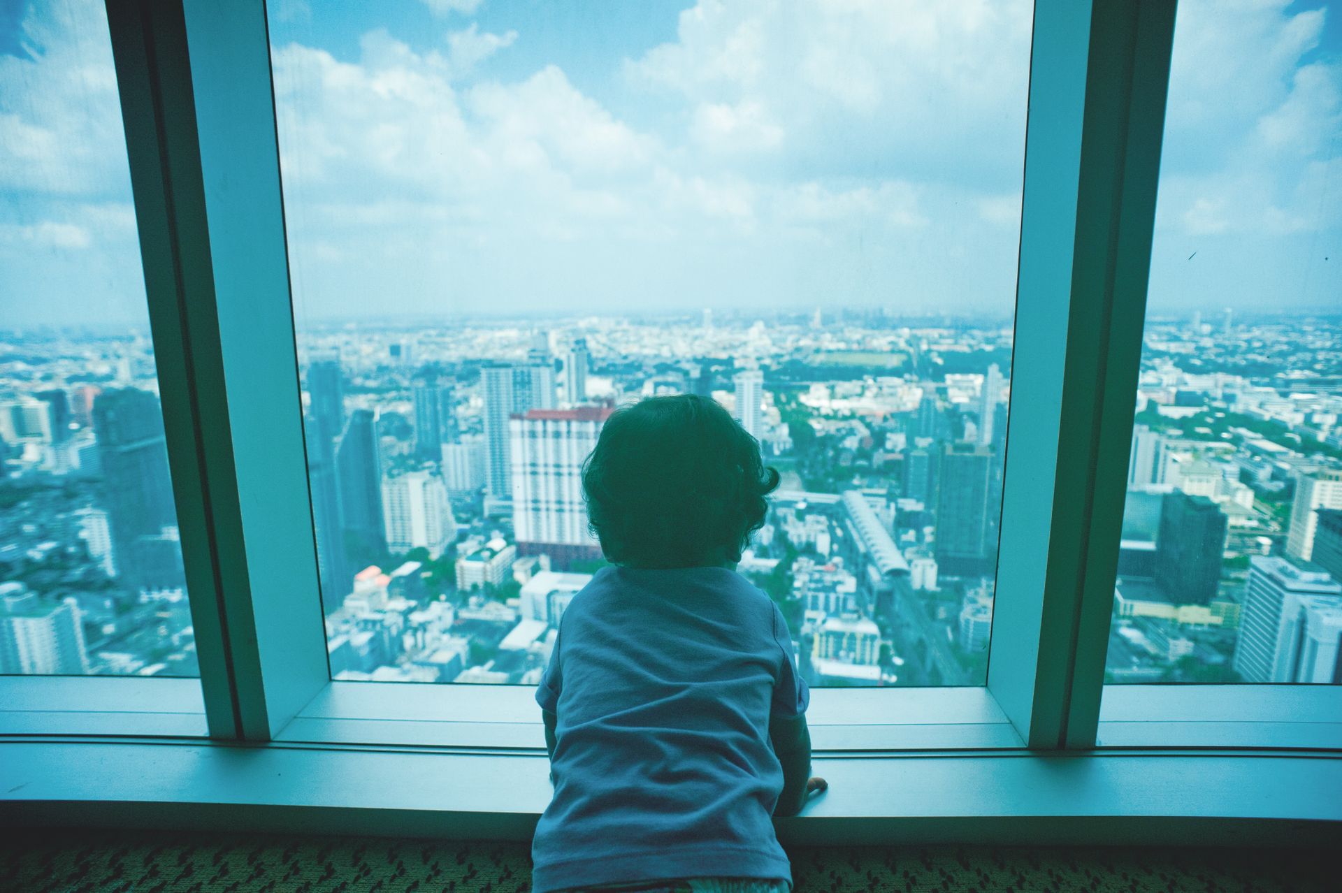 Toddler Looking Through Clear Glass Window