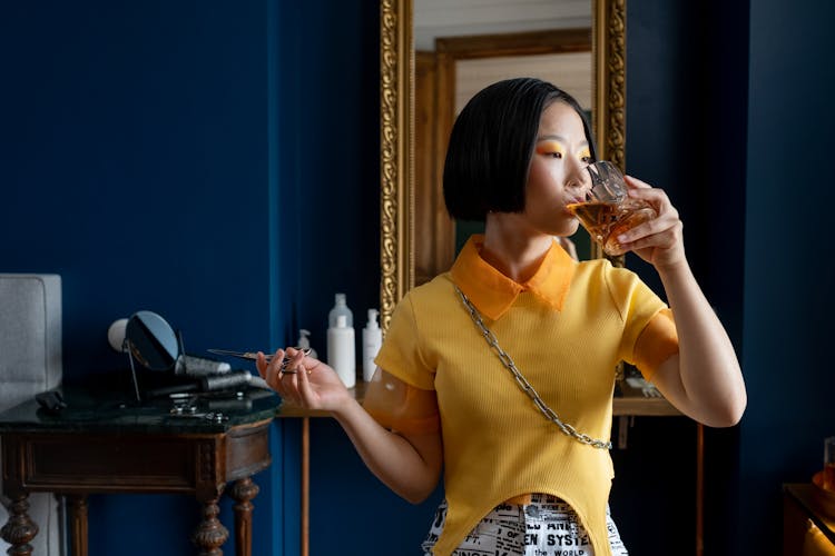 Woman Holding Scissors Drinking Whiskey