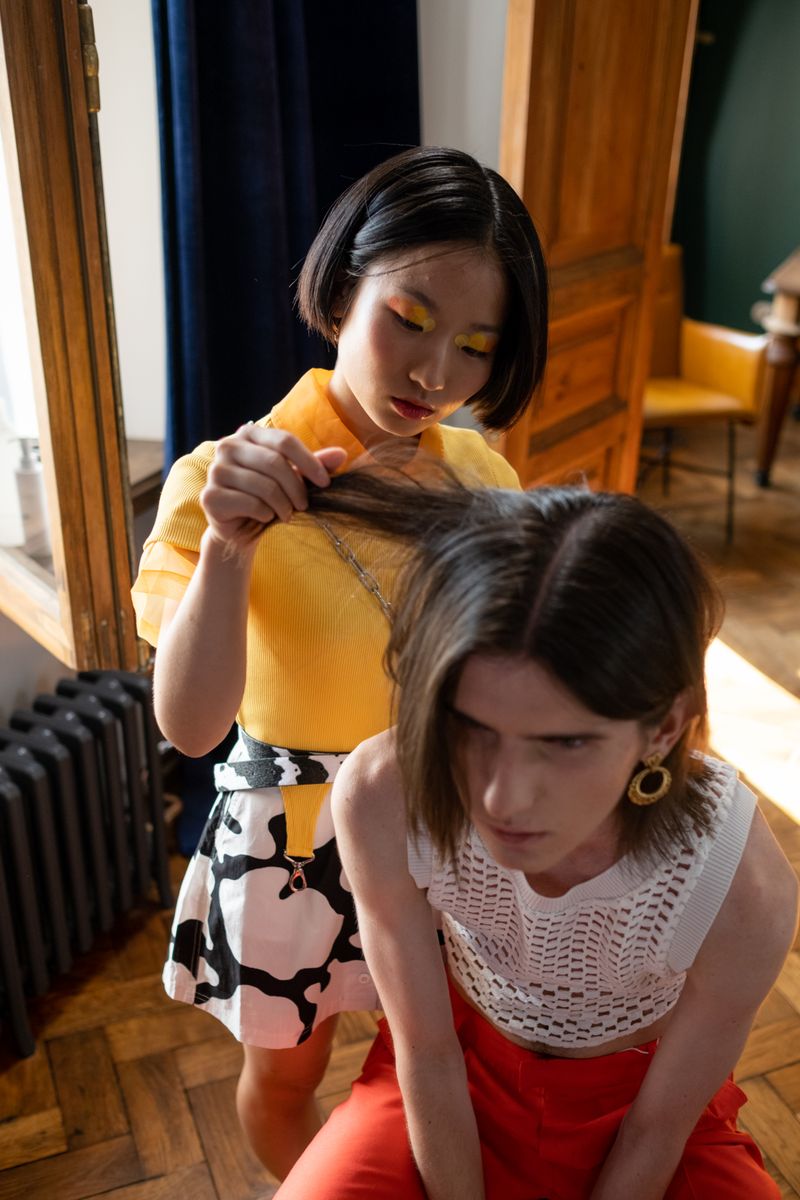 Woman barber styling a client's hair
