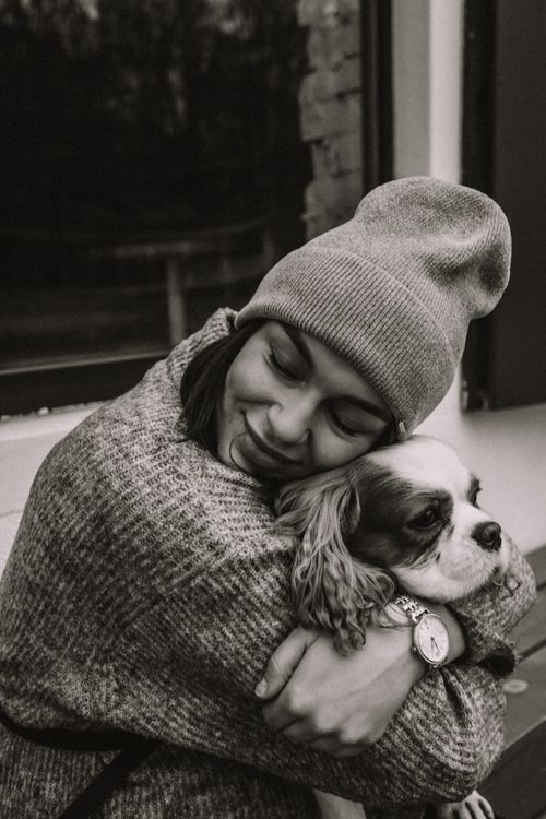 Free Black and white photo of a woman hugging her pet dog warmly, showcasing friendship and comfort. Stock Photo