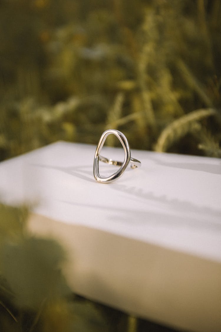 Silver Ring On White Surface