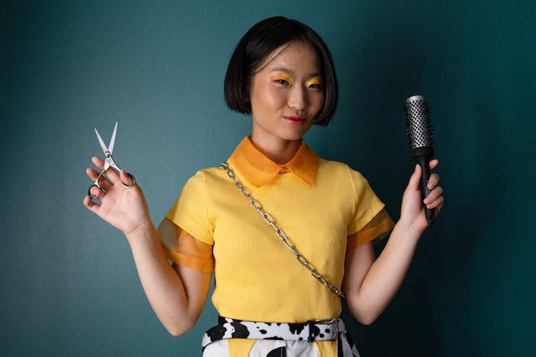 Smiling Woman With Hairbrush And Scissors