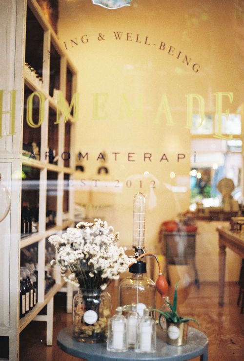 Free A warm, inviting aromatherapy shopfront showcasing flowers and essential oils. Stock Photo
