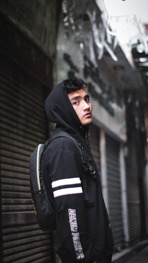 Phot of a Man Wearing a White and Black Hoodie
