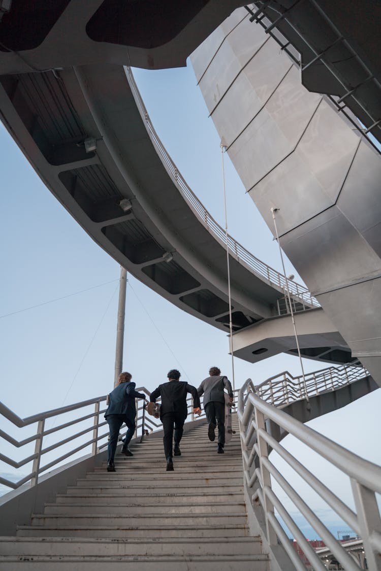 Photo Of Men Running Up The Stairs