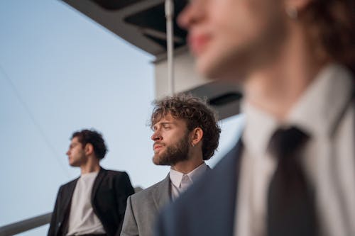 Bearded Man in Gray Suit Looking Over Shoulder