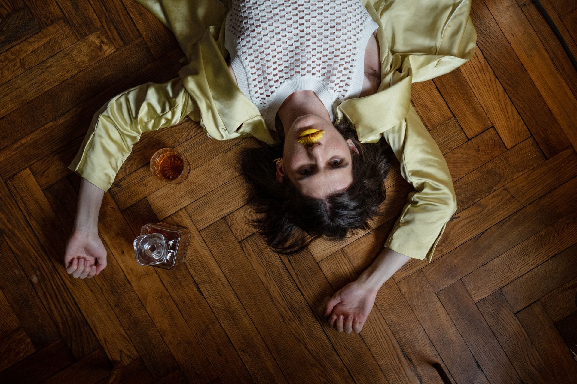 Man Laying on the Floor with Whiskey
