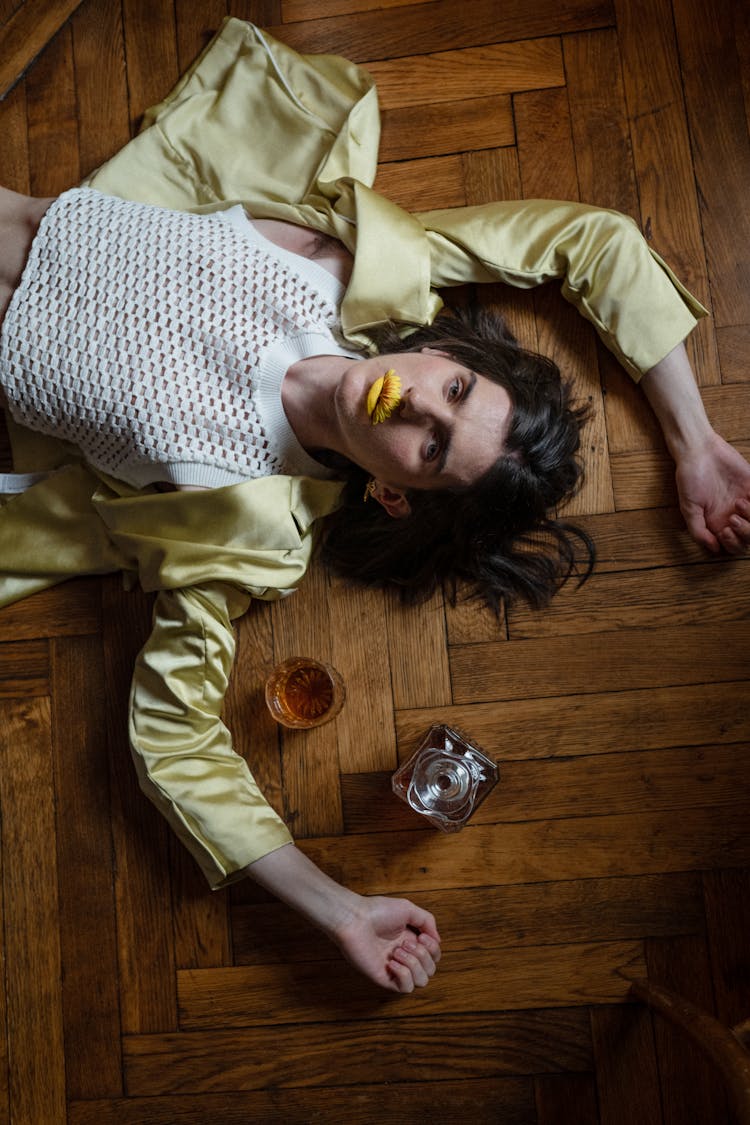 Man Laying On The Floor And Whiskey