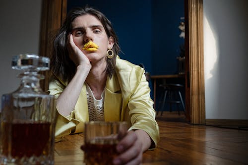 Man on the Floor Holding Glass of Whiskey