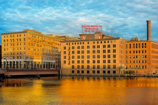 Captivating view of Boston Wharf's industrial architecture reflected in the river during daylight.