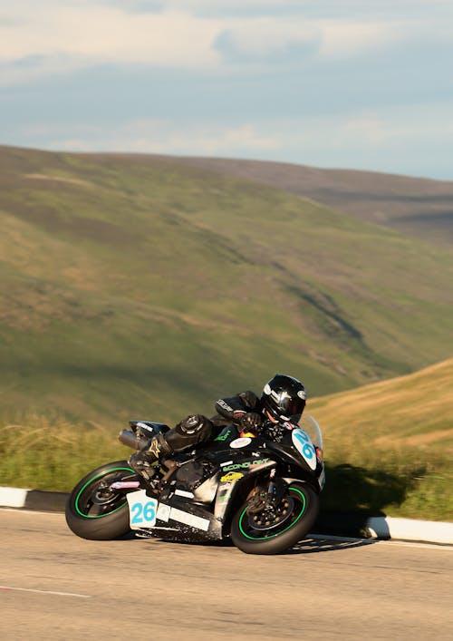 Man Riding on Motorbike on Road