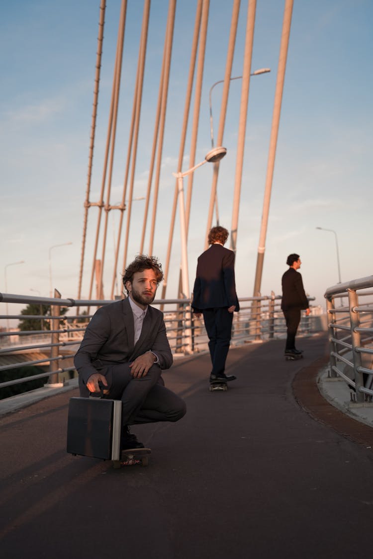 Men Skateboarding On A Walkway